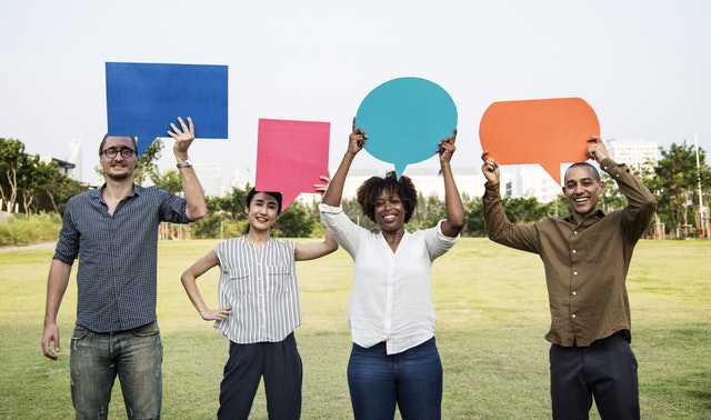 Group of diverse people holding thought bubbles above their heads