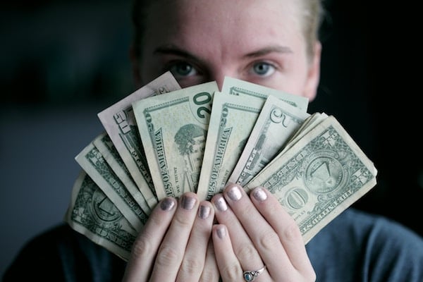 Man holding a fan of cash