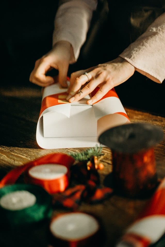 person wrapping a present