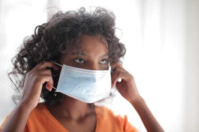 woman-in-orange-crew-neck-shirt-wearing-white-face-mask