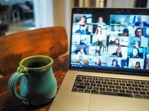 Computer screen shows people in online conference